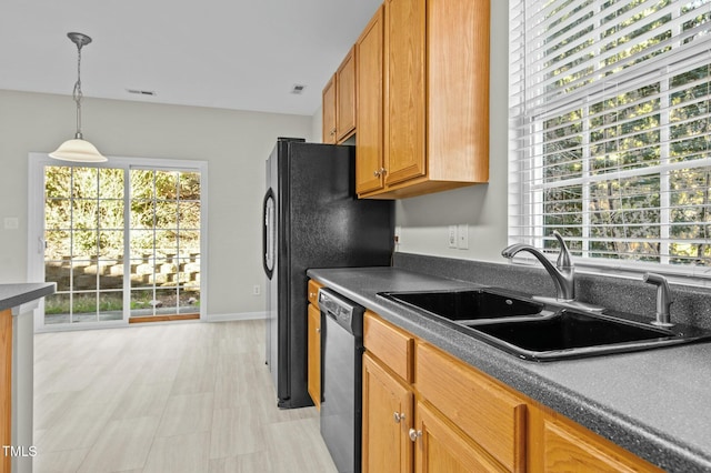 kitchen with sink, decorative light fixtures, and dishwasher