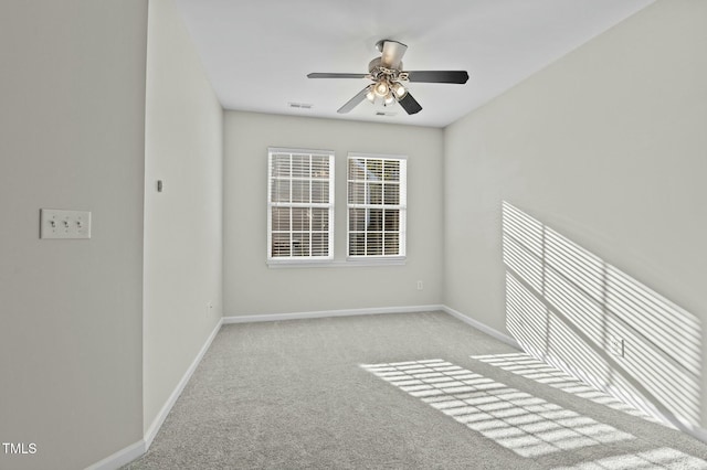 carpeted spare room with ceiling fan