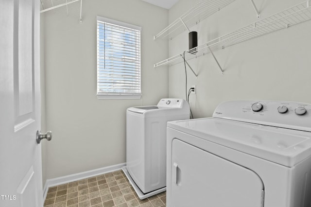 laundry area featuring washing machine and clothes dryer and a healthy amount of sunlight