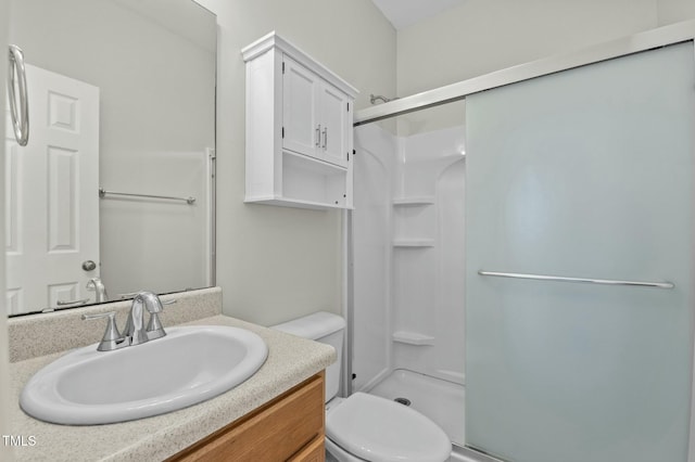 bathroom with toilet, a shower with door, and vanity