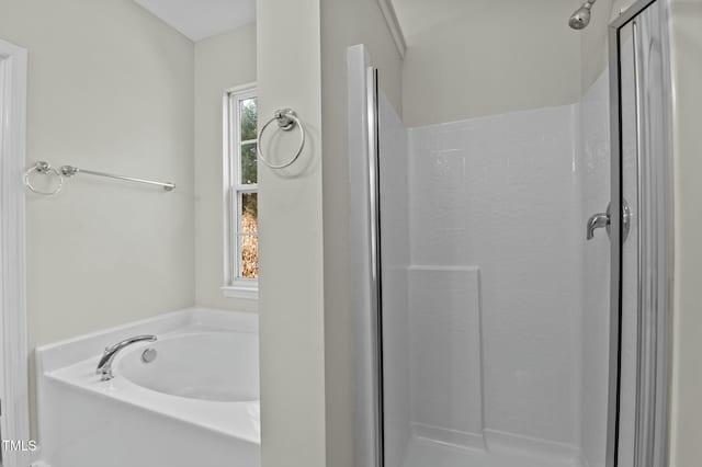 bathroom featuring plus walk in shower and a wealth of natural light