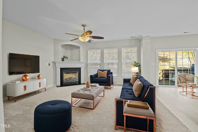 carpeted living room featuring ceiling fan