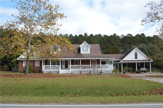 view of front of house featuring a carport, covered porch, and a front yard