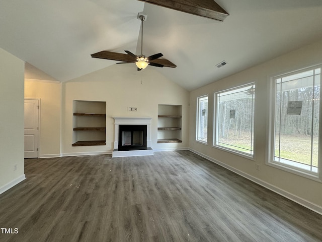 unfurnished living room with baseboards, visible vents, built in features, a fireplace with raised hearth, and wood finished floors