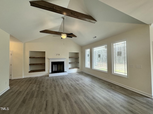 unfurnished living room featuring baseboards, visible vents, a fireplace with raised hearth, dark wood-type flooring, and built in shelves