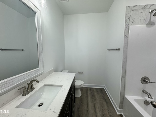 full bath with visible vents, toilet, vanity, wood finished floors, and baseboards