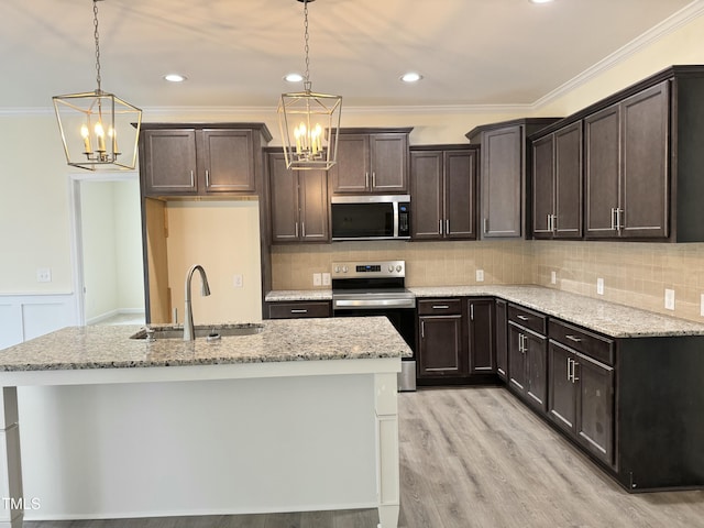 kitchen featuring stainless steel appliances, dark brown cabinets, a sink, and an inviting chandelier