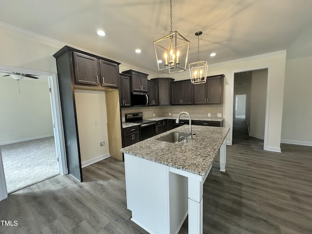 kitchen featuring appliances with stainless steel finishes, crown molding, a sink, and decorative backsplash