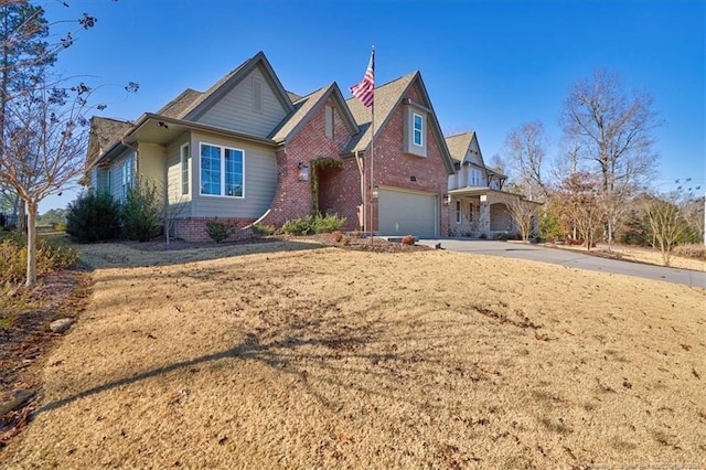 view of front of property with a front lawn and a garage