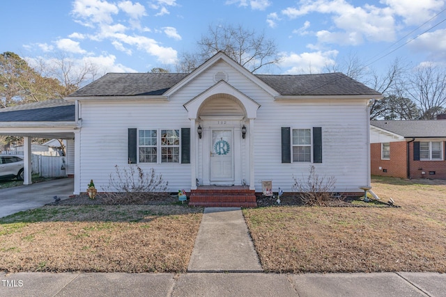 bungalow with a front lawn and a carport