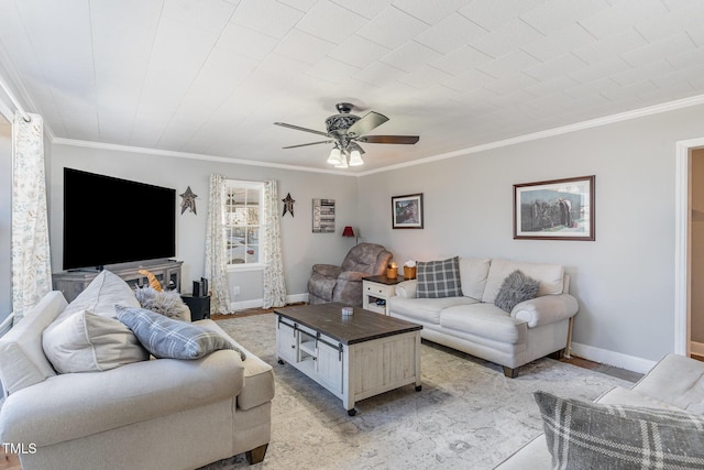 living room featuring ceiling fan and ornamental molding