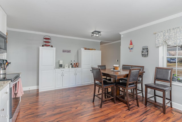 dining room featuring crown molding and dark wood-type flooring