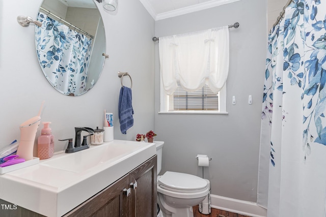 bathroom with plenty of natural light, toilet, vanity, and ornamental molding