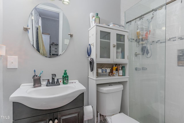 bathroom featuring toilet, vanity, and a shower with curtain