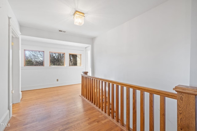 hall with light hardwood / wood-style flooring