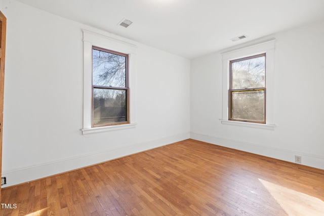 unfurnished room with wood-type flooring