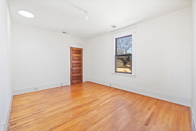 empty room with light hardwood / wood-style floors