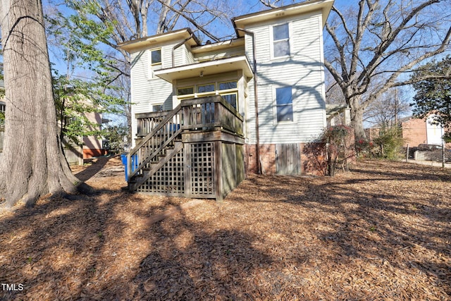 back of house with a wooden deck