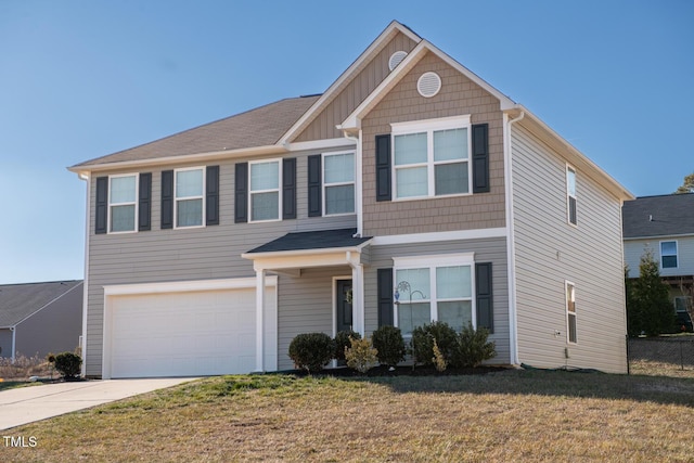 view of front of home with a garage and a front lawn