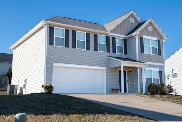 view of front of house featuring a garage and central AC