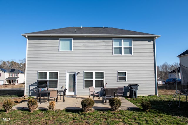 back of property featuring a patio area and a fire pit