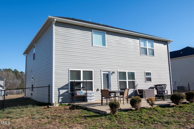 rear view of property with central AC, a yard, and a patio