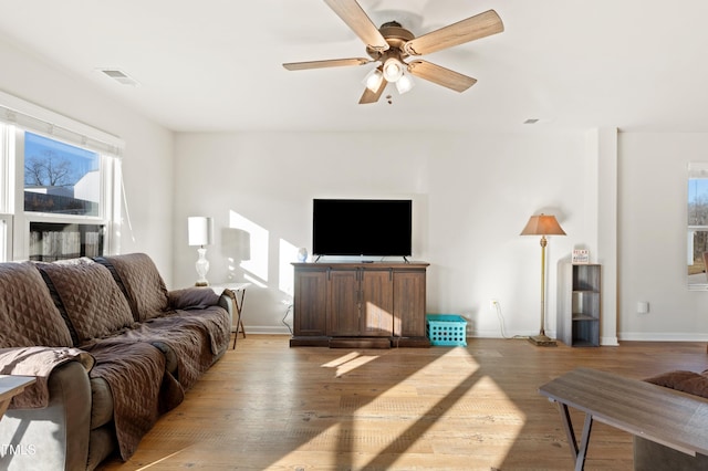 living room featuring light hardwood / wood-style floors and ceiling fan