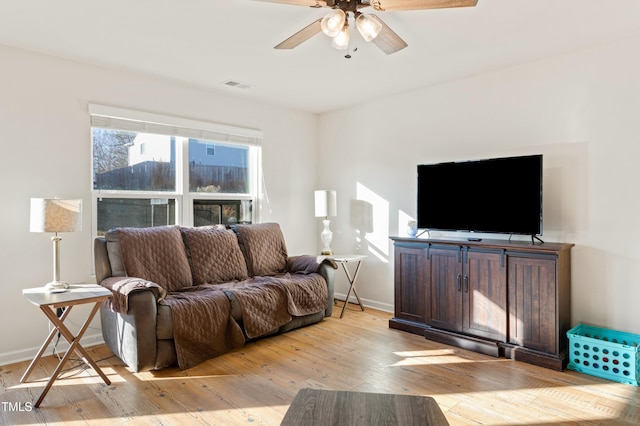 living room with ceiling fan and light hardwood / wood-style floors