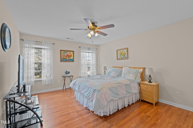 bedroom featuring light hardwood / wood-style floors and ceiling fan