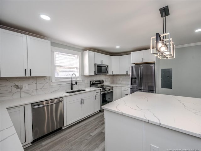 kitchen featuring white cabinets, appliances with stainless steel finishes, sink, and pendant lighting