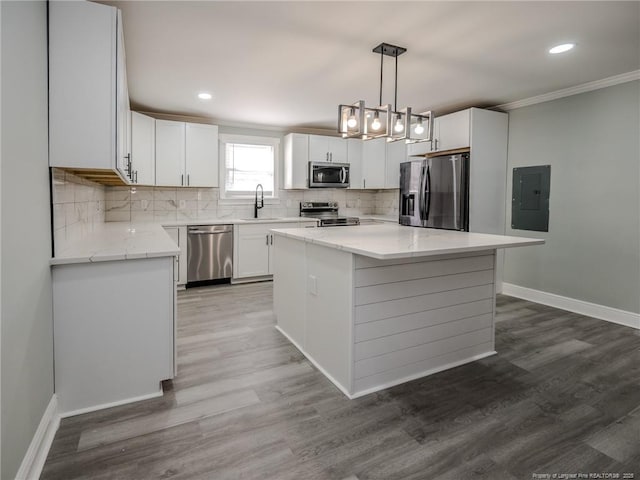 kitchen featuring pendant lighting, white cabinetry, a center island, and stainless steel appliances