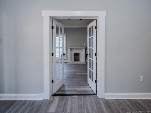 hall featuring dark hardwood / wood-style flooring and french doors