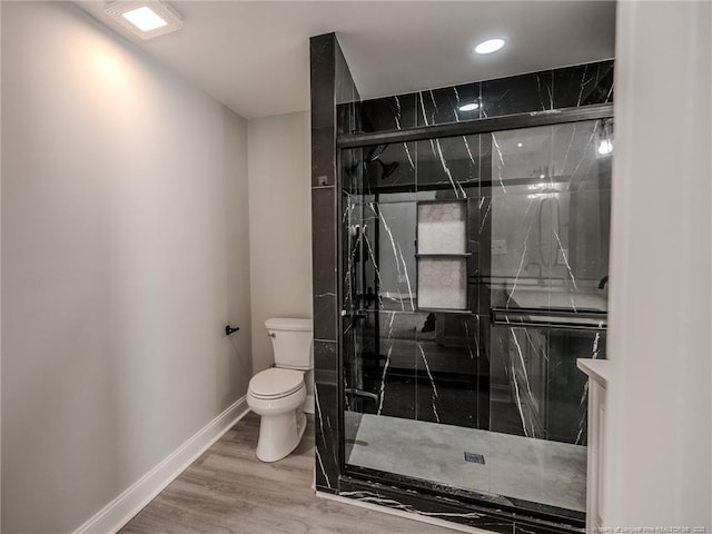 bathroom with toilet, wood-type flooring, walk in shower, and vanity