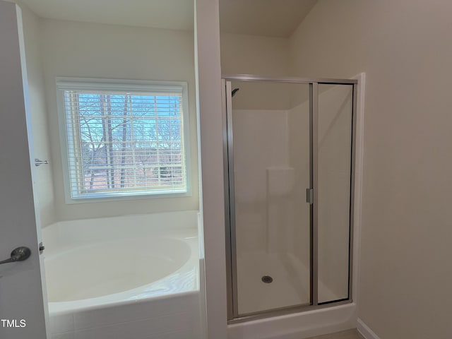 bathroom with shower with separate bathtub