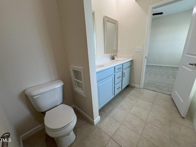 bathroom with vanity, tile patterned flooring, and toilet