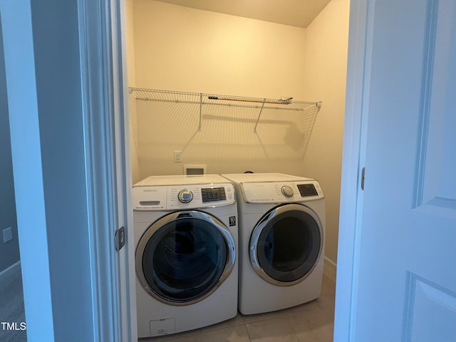 washroom featuring independent washer and dryer and tile patterned floors