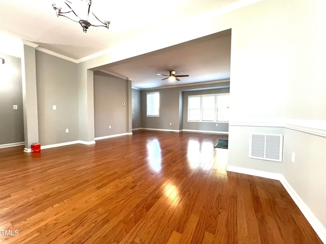 unfurnished room featuring crown molding, ceiling fan with notable chandelier, and hardwood / wood-style flooring