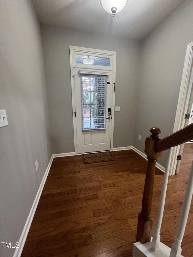 foyer entrance with dark hardwood / wood-style floors