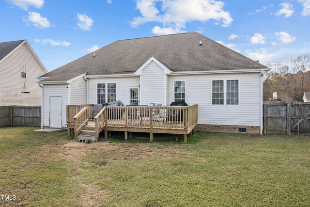 rear view of property with a wooden deck and a yard