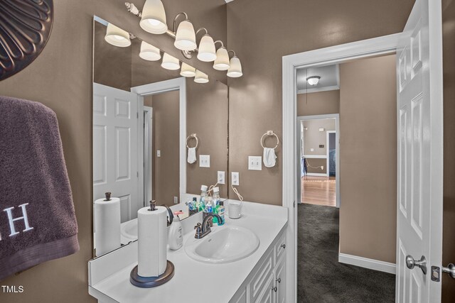 bathroom featuring crown molding and vanity