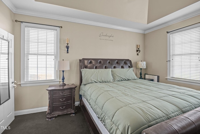 bedroom with ornamental molding, dark carpet, and a raised ceiling