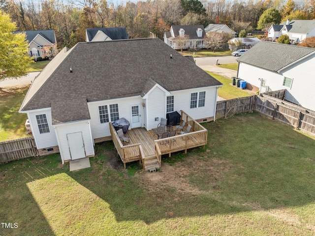 back of house featuring a deck and a lawn