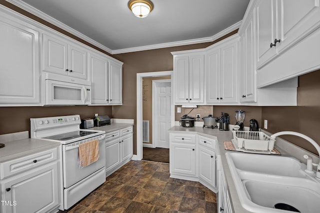 kitchen featuring white cabinetry, sink, white appliances, and crown molding