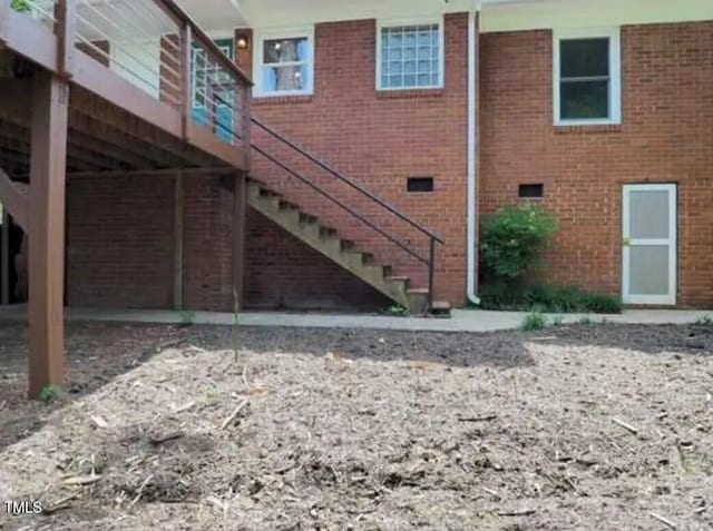 exterior space with stairs and brick siding