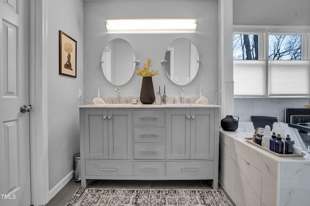 bathroom featuring double vanity, tile patterned flooring, and a sink