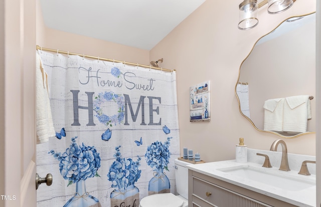 bathroom with toilet, walk in shower, and vanity