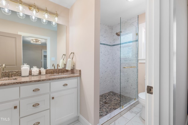 bathroom featuring tiled shower, toilet, and vanity