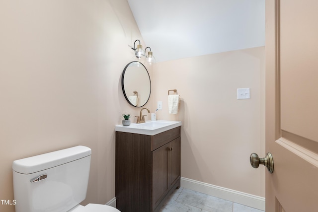 bathroom featuring toilet, vanity, and tile patterned flooring