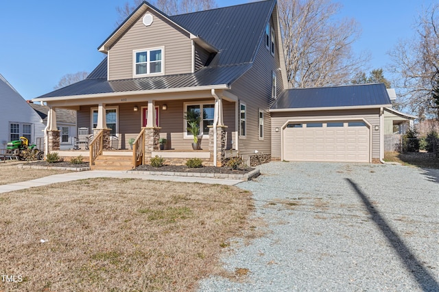 view of front of house with covered porch, a front yard, and a garage