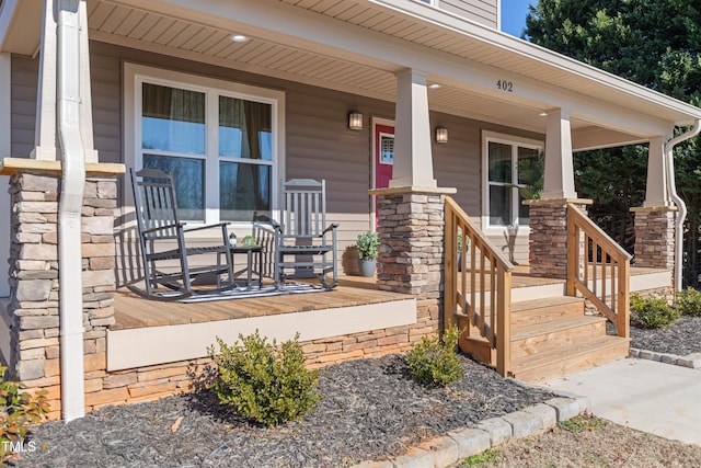 view of exterior entry with covered porch